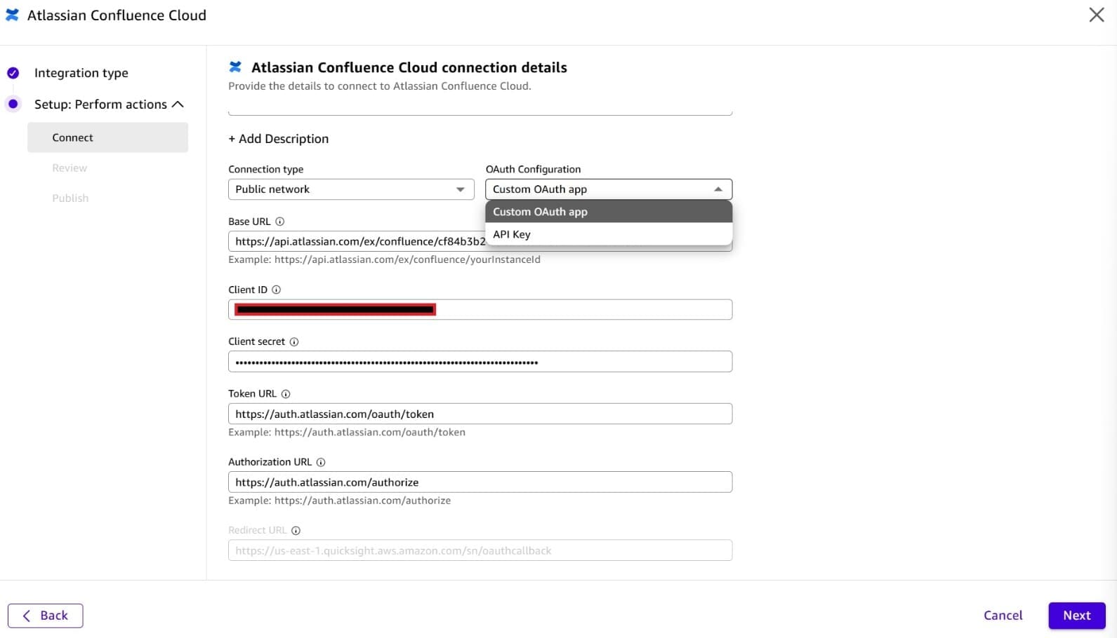 Screenshot of the 'Atlassian Confluence Cloud connection details' setup dialog in Amazon Quick. The form shows Connection type: 'Public network', OAuth Configuration dropdown set to 'Custom OAuth app' (with a dropdown showing 'Custom OAuth app' and 'API Key' options), a Base URL field (partially redacted), Client ID (redacted, highlighted with red border), Client secret (masked), Token URL (https://auth.atlassian.com/oauth/token), and Authorization URL (https://auth.atlassian.com/authorize). Navigation buttons Back and Next are visible at the bottom. This image shows how to configure custom OAuth credentials when setting up a Confluence Cloud connector in Amazon Quick.