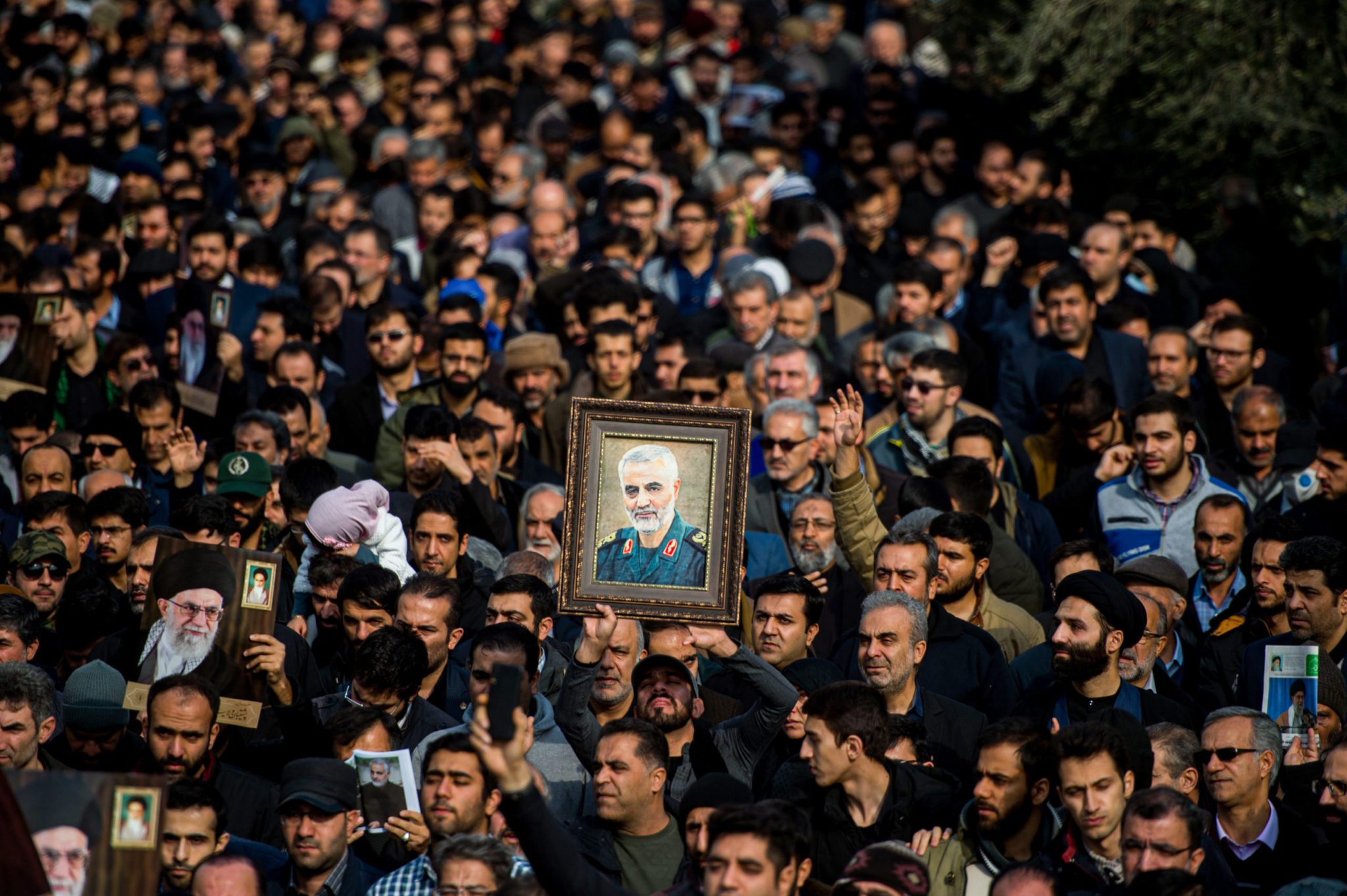 Protesters hold up an image of Qassem Soleimani, an Iranian commander, during a demonstration following the U.S. airstrike in Iraq which killed him, in Tehran, Iran, on Friday, Jan. 3, 2020. Qassem Soleimani, who led proxy militias that extended Irans power across the Middle East, was killed in a drone attack in Baghdad authorized by President Trump, the Defense Department said in a statement late Thursday. Photographer: Ali Mohammadi/Bloomberg via Getty Images