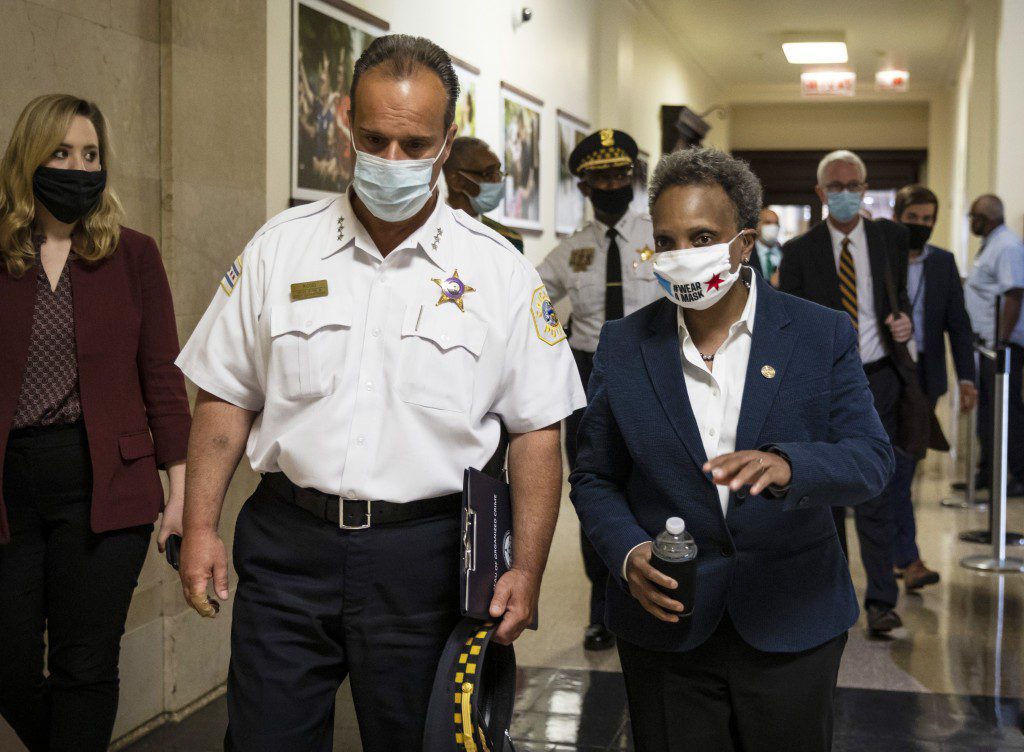 Mayor Lori Lightfoot chats with Chicago Police Department First Deputy Superintendent Anthony Riccio after a news conference in Chicago on Thursday afternoon, June 11, 2020, about a group of Chicago police officers in the congressman's campaign office while looters hit nearby stores. More than a dozen officers and supervisors from the Chicago Police were captured on video 