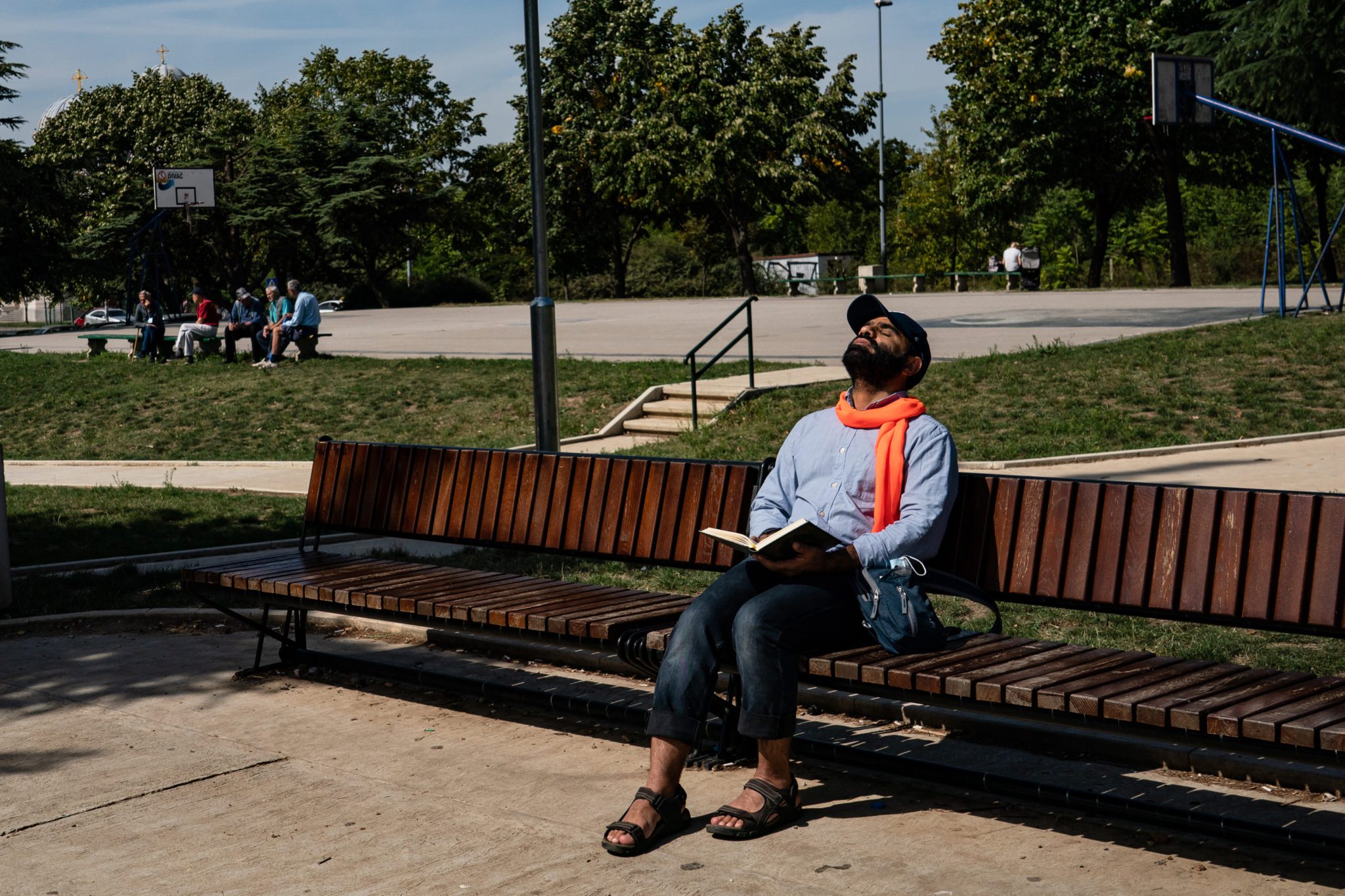 BELGRADE, SERBIA - SEPTEMBER 8: Mansoor Adayfi, former Guantanamo detainee from Yemen, reacts from a pain in his neck as he reads the Quran at a park near his apartment in Belgrade, Serbia, Wednesday, September 8, 2021. Adayfi said was harassed  by locals at the park multiple times before. (Photo by Salwan Georges/The Washington Post via Getty Images)