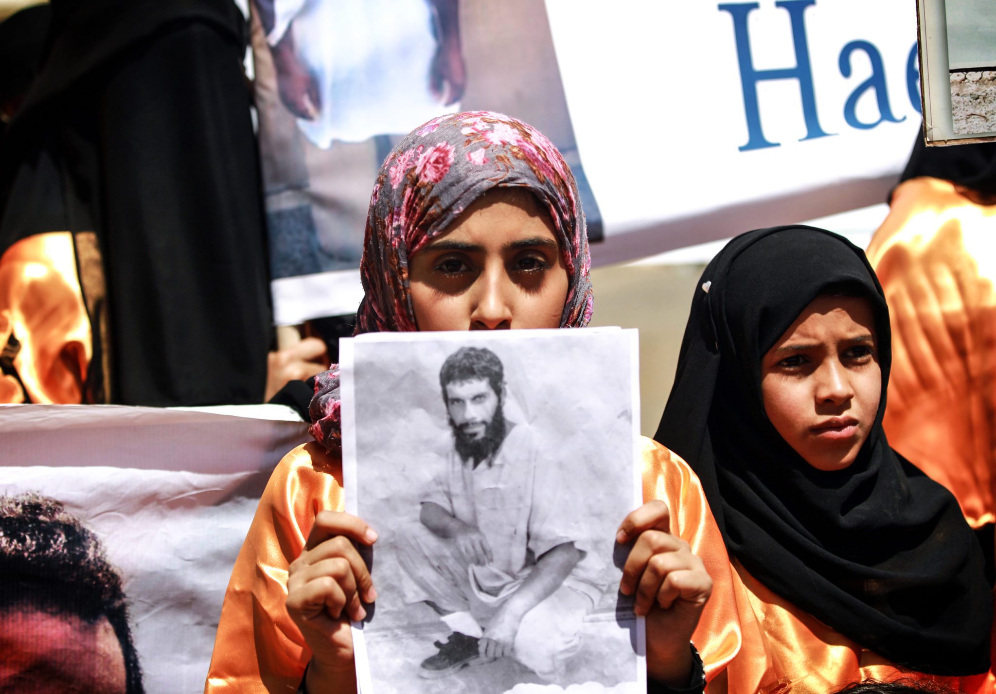 Yemenis wearing orange jumpsuits, similar to those worn by prisoners at the US detention centre in Guantanamo Bay, hold a protest demanding the release of inmates on hunger strike, on April 16, 2013  outside the US embassy in Sanaa.  Attorneys representing inmates at the prison have said most of the estimated 130 detainees at Guantanamo's Camp Six wing, which houses 